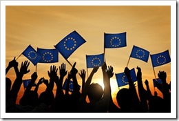 Group of People Waving European Union Flags in Back Lit